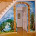 under stairs garden mural with trees, water, bridge